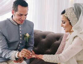 Couple exchanging rings during muslim ceremony.