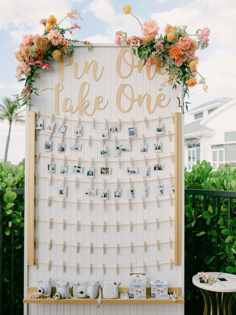 wedding favor display with polaroid photos on clothespins