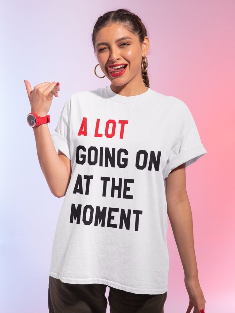 Model wears a graphic tee that reads "A lot going on at the moment."