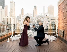 Man proposing to his girlfriend on a rooftop