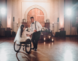 Disabled couple dancing on dancefloor at handicap-accessible wedding venue