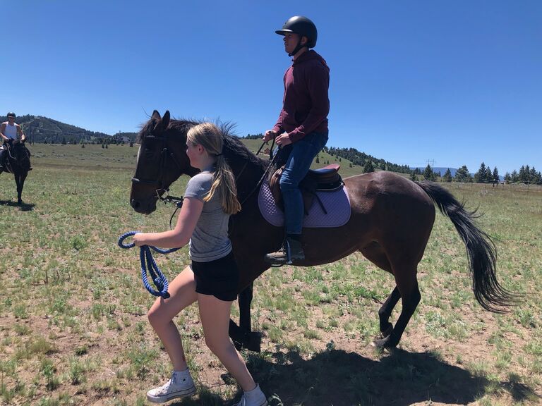 Rach and Sherm ride horses.