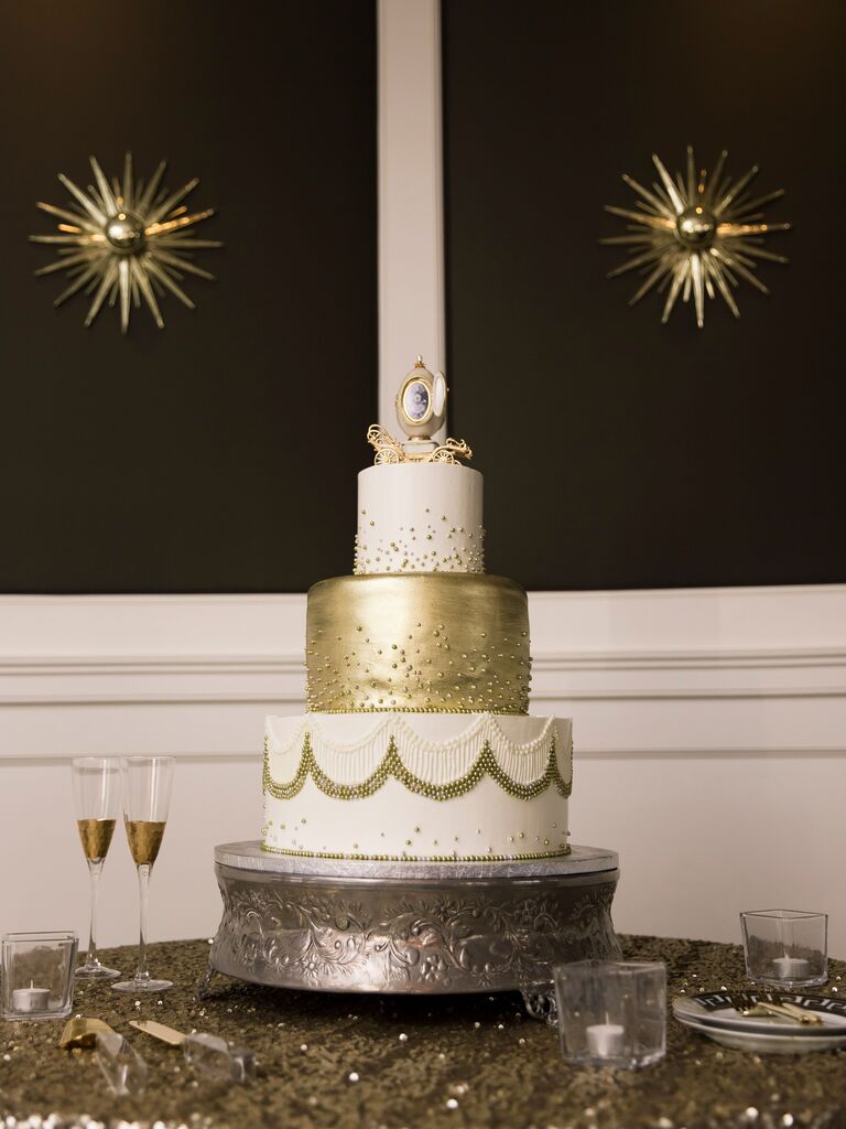 three tier new year's eve wedding cake with metallic gold middle tier and white and gold dragees