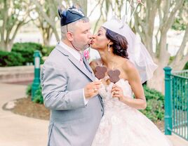 Bride and groom wearing Mickey Mouse ears at Disney-themed wedding