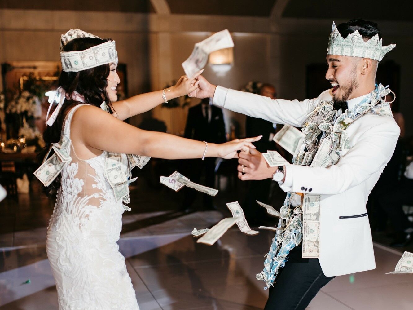 Couple engages in a traditional money dance. 