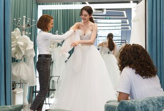 Woman trying on a wedding dress in a bridal shop