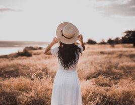 Woman standing alone in field