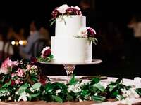 classic simple white wedding cake with red and white flowers
