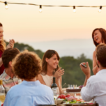 Friends clapping while enjoying dinner party