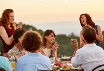 Friends clapping while enjoying dinner party
