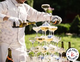 Wedding bartender pouring a champagne tower