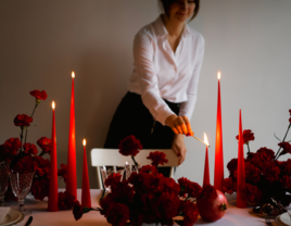 Woman lighting candles on DIY wedding centerpiece