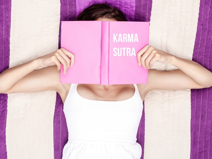 Woman reading a karma sutra book