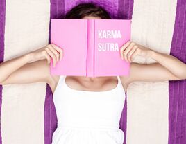 Woman reading a karma sutra book