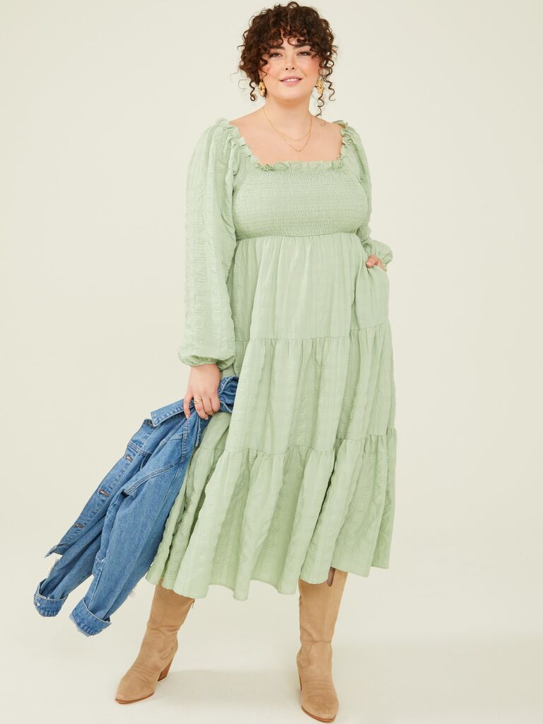 A sage maxi dress with long lantern sleeves, a ruffled square neckline, and smock bodice from Arula