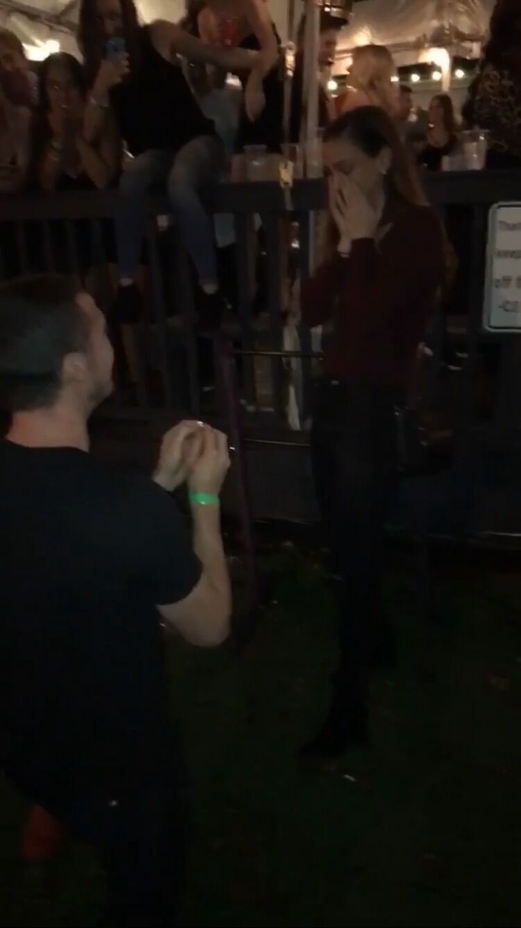 Sean proposed to Zoe at midnight with close friends cheering them on at Caswell’s Station. 