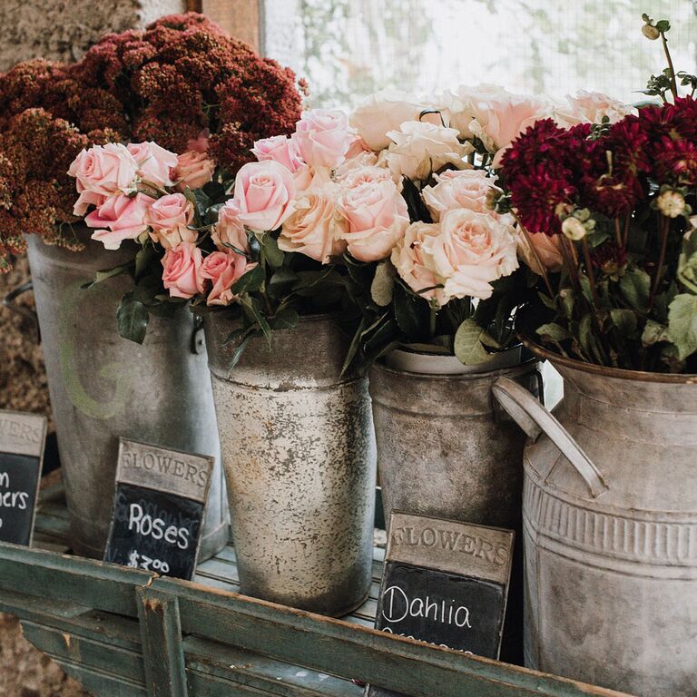 European-inspired metal buckets with fresh roses and delphiniums as wedding decor