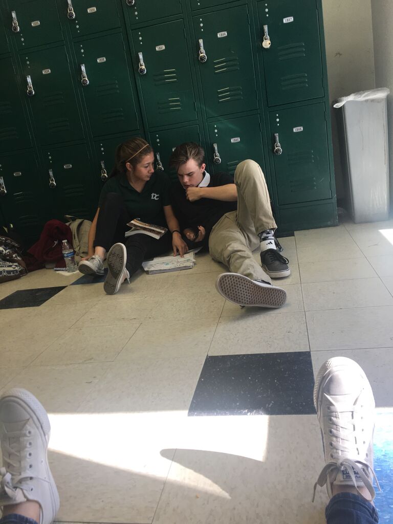 Two sophomores in their natural habitat studying during lunch, and a boy helping a girl with homework