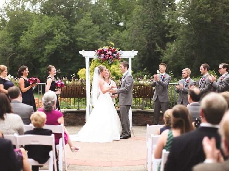 Couple exchanging their vows outside in the garden patio