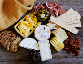Cheese board gift box with pairings like crackers and jams