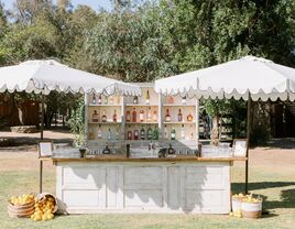 Outdoor wedding reception space with personalized bar