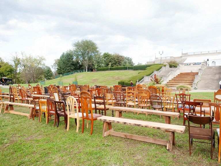 Mismatched antique wood chairs and benches for wedding ceremony seating