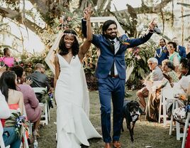 Couple walking down the aisle after wedding ceremony.