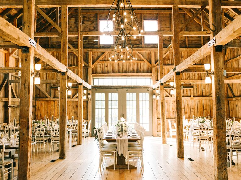 Inside view of wooden barn venue with tables and chairs