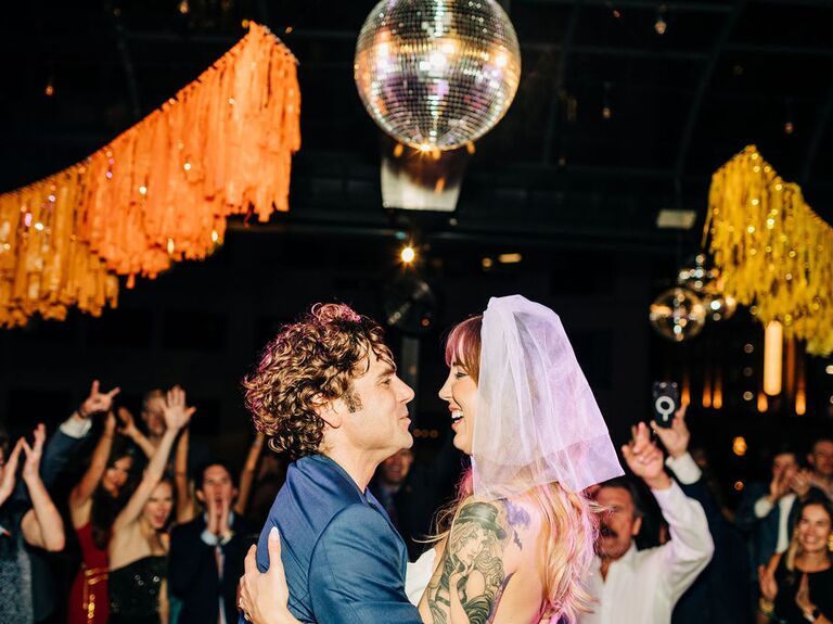 Couple dancing under disco ball and streamers