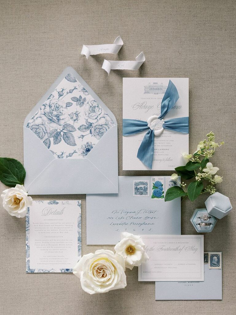 classic wedding invitation suite with blue floral envelope liner and blue ribbon detailing