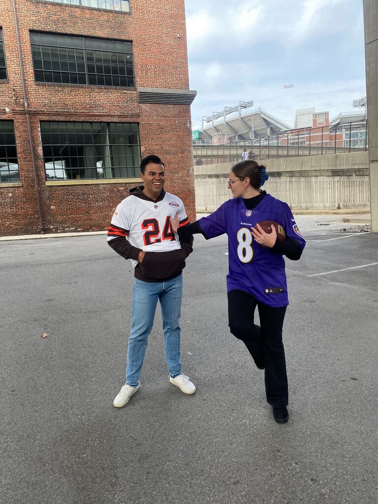Olivia and Deon cheering on the Ravens. 
