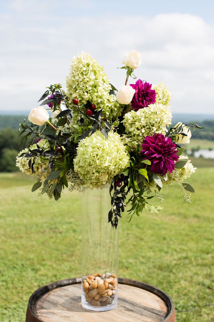 Green Floral Arrangement In Tall Glass Vase