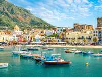 ischia italy village and castle in backdrop gorgeous photo of boats and the island's architectural appeal