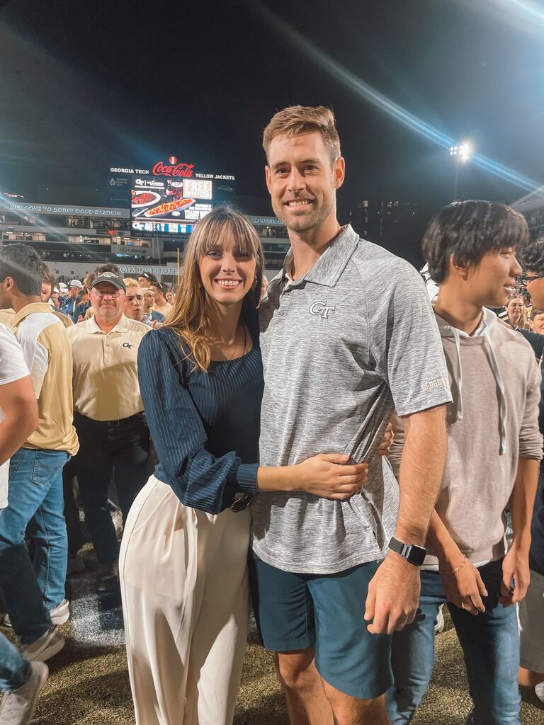 Drew achieves the impossible and somehow gets Allie to attend more Georgia Tech games in a season than UGA. Here they are storming the field. (Go Dawgs, though). 