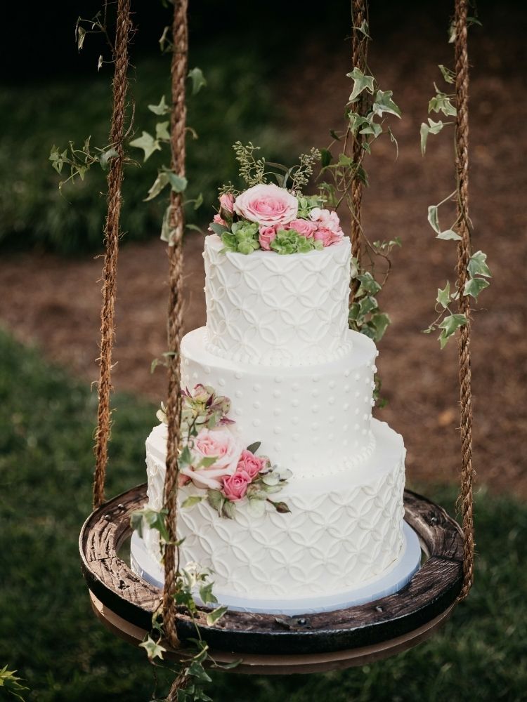textured wedding cake on cake swing 