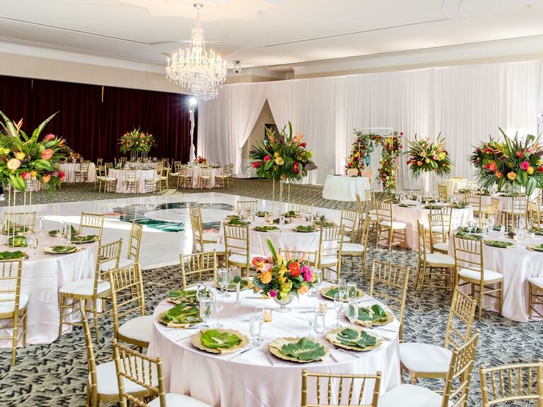 Inside reception space with gold chivari chairs and circle tables