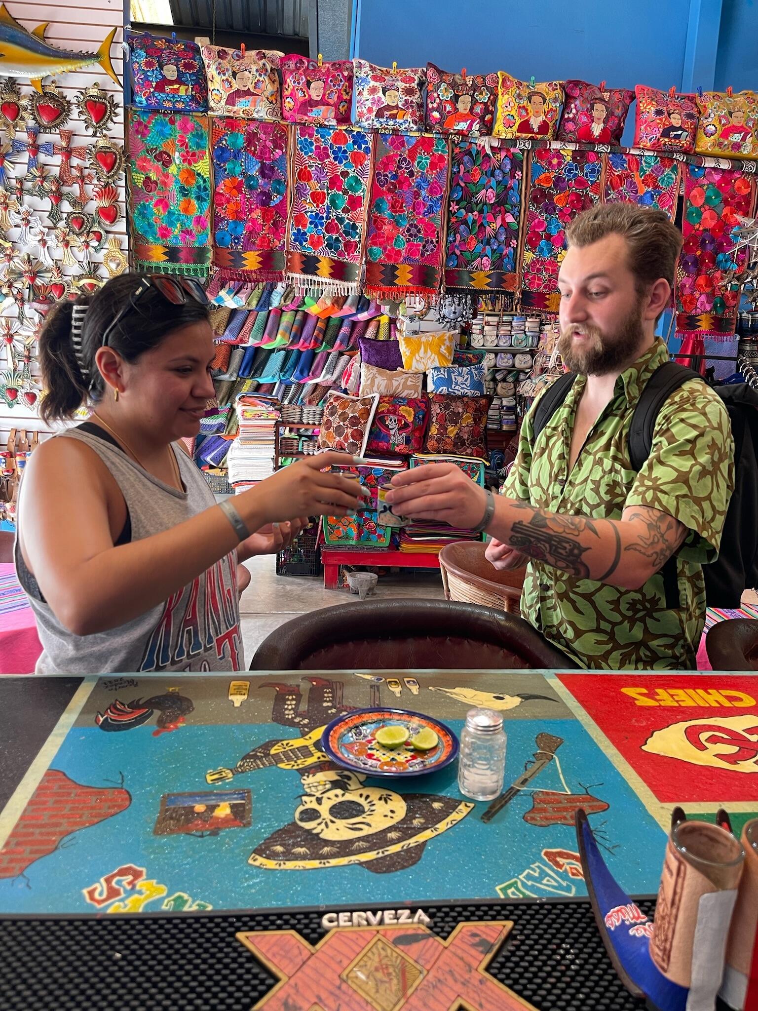 In our natural element, shooting tequila in a market in Cabo.