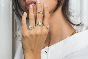 Stack of trendy engagement rings on a hand 