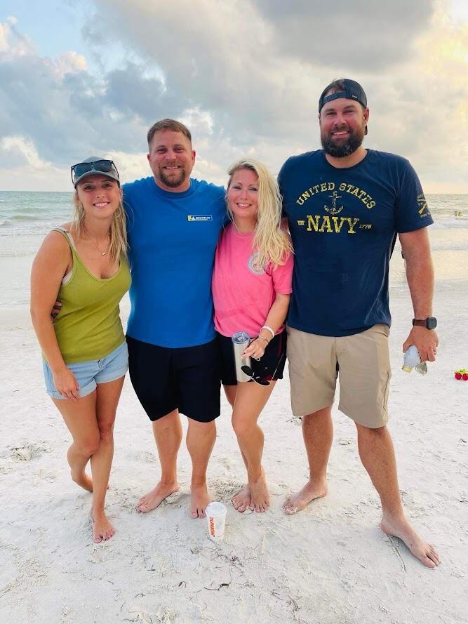 Capri and Clint with Holly and Sean after winning the cornhole tournament at Holly's annual family extravaganza. 