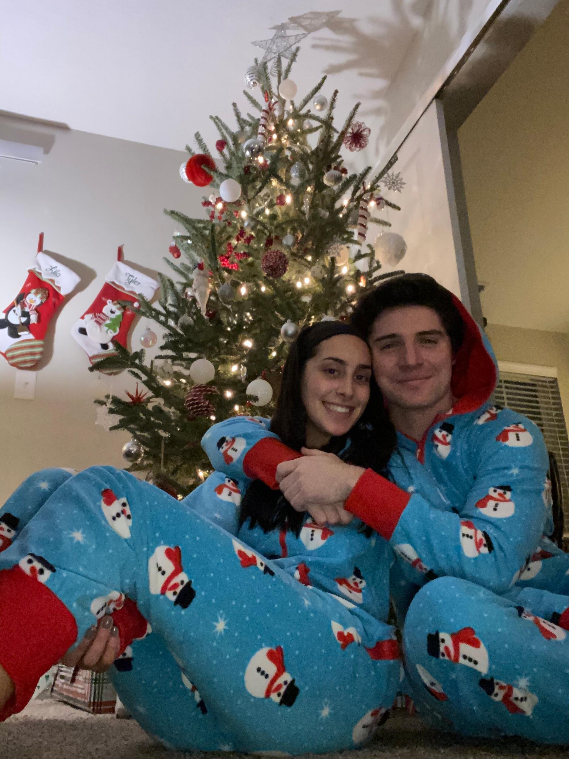 Lila and Tyler get into the Christmas spirit with matching onesies.