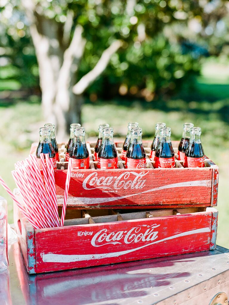 vintage crates with glass coca cola bottles and red striped straws