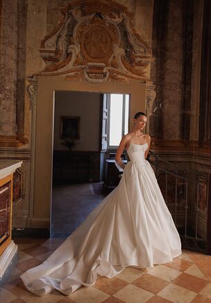 Deep round neck corset with pointed bottom and voluminous smooth fabric skirt.