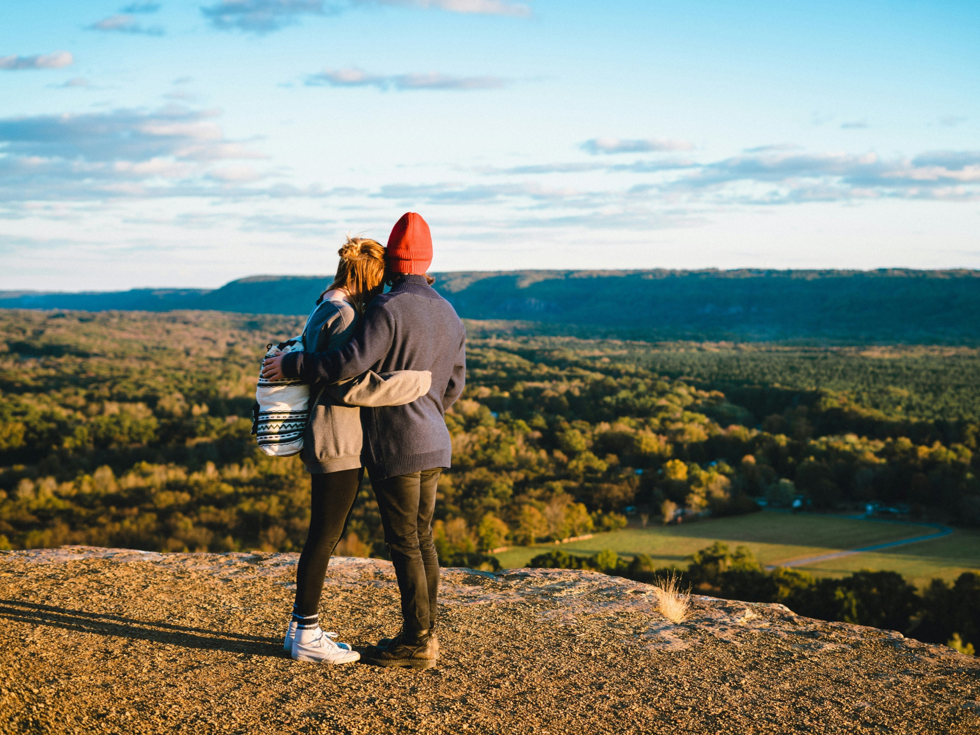 Couple hugging each other on hill in Connecticut