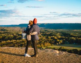 Couple hugging each other on hill in Connecticut