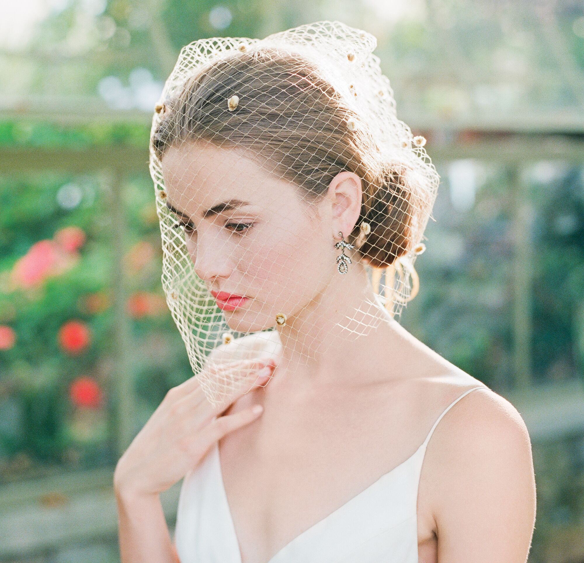 bride with birdcage veil and coral lipstick 