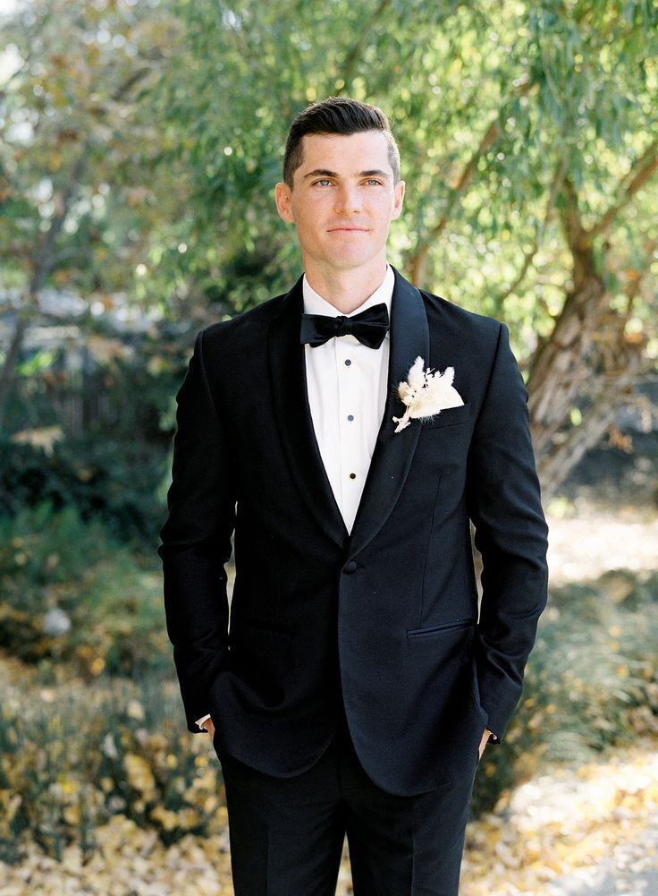 Groom in tux with white boutonniere