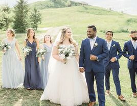 Bride and groom walking in front of wedding party