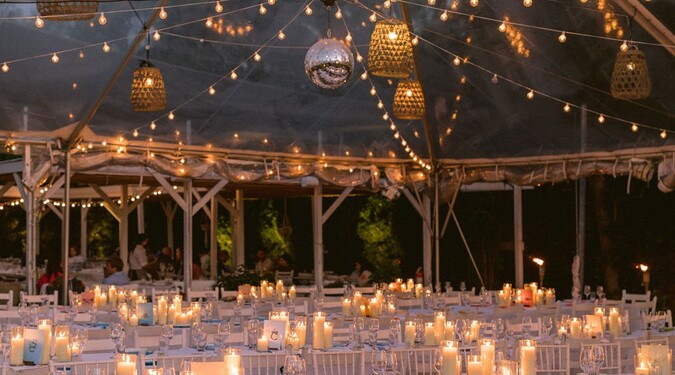 Candlelit wedding reception under a decorated tent at Calissa Long Island
