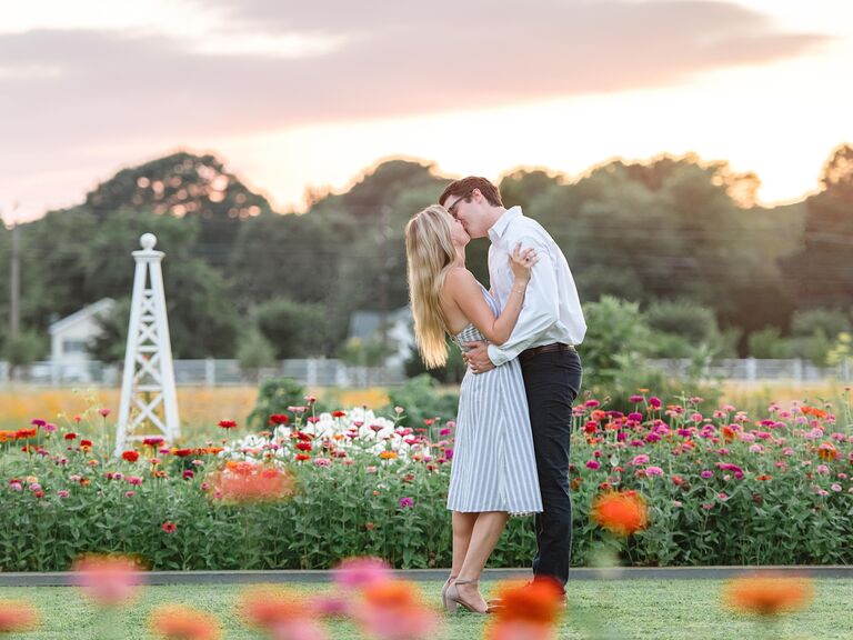 Couple kiss in a botanic garden. 