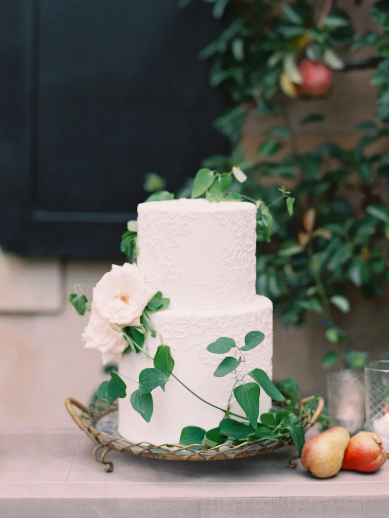 white two-tier wedding cake with white roses